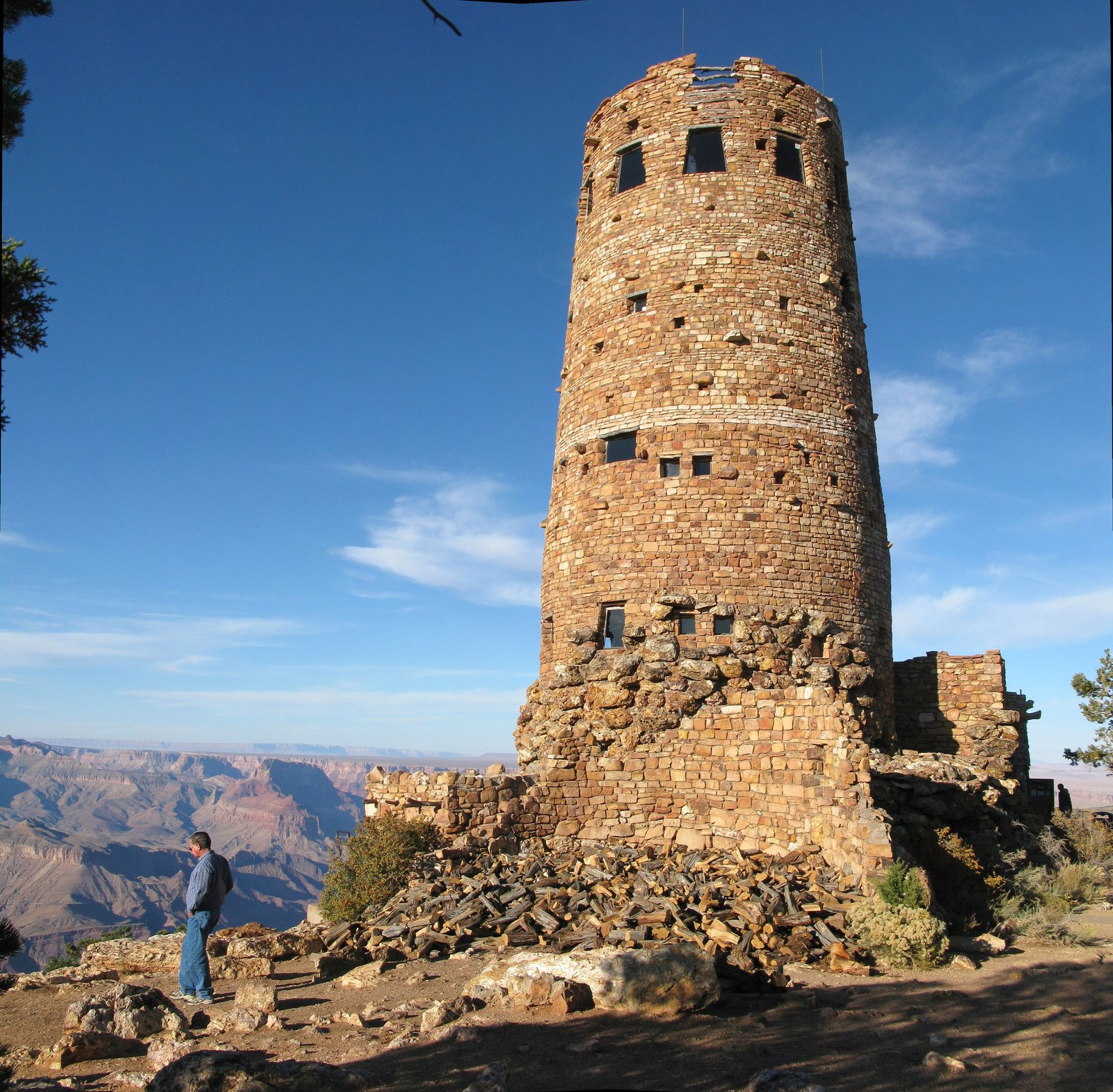 The Desert View Watchtower against a blue sky with the canyon behind