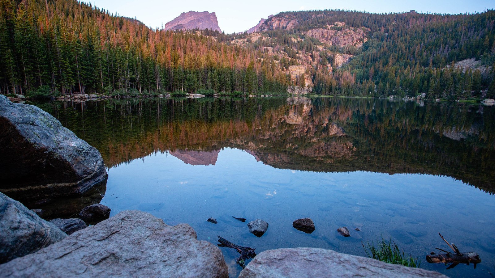 Bear Lake at dawn with Hallett Peak reflected in still water